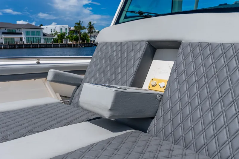 Slide: The Image of 2011 Boston Whaler 370 Outrage boat interior with quilted gray seating. - 53