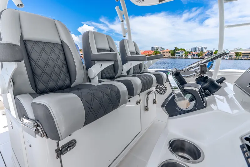 Slide: The Image of Luxury seating and helm of 2011 Boston Whaler 370 Outrage boat, with waterfront view. - 26
