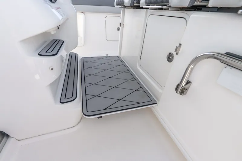 Slide: The Image of Interior view of a 2011 Boston Whaler 370 Outrage boat, featuring storage compartments. - 30