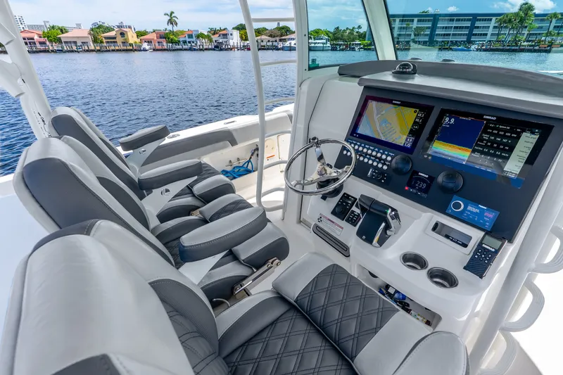 Slide: The Image of Interior view of 2011 Boston Whaler 370 Outrage boat cockpit with advanced navigation systems. - 29