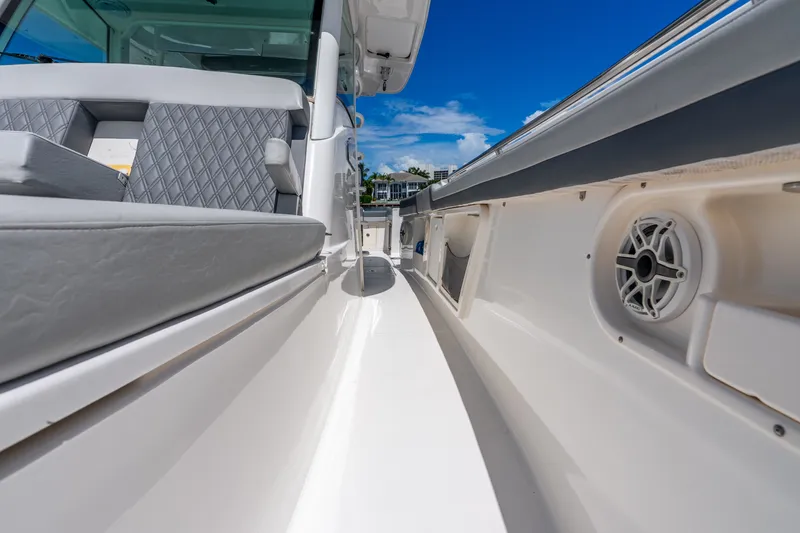 Slide: The Image of 2011 Boston Whaler 370 Outrage boat interior with cushioned seating and speaker. - 52