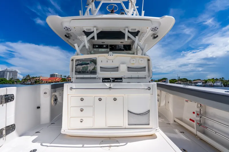 Slide: The Image of 2011 Boston Whaler 370 Outrage boat deck with storage and equipment, under a clear blue sky. - 23