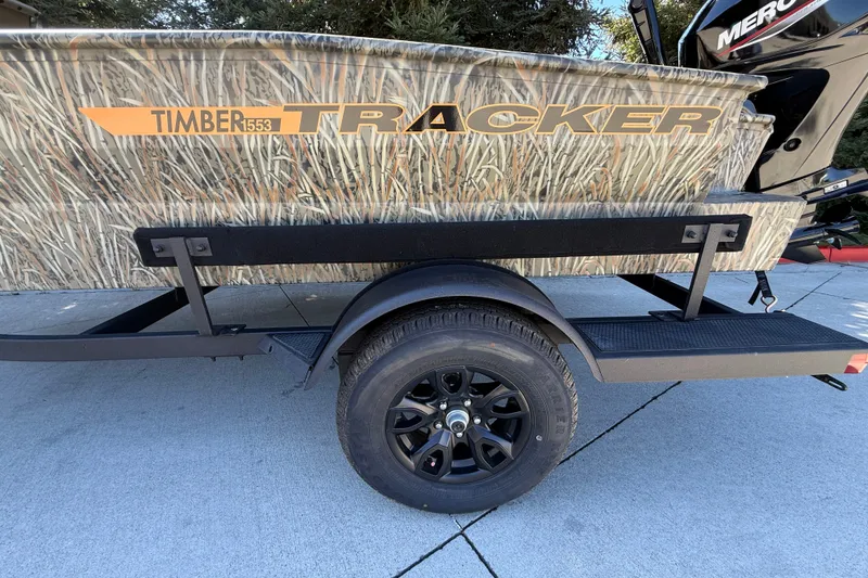 Slide: The Image of 2027 Tracker Grizzly 1553 Timber boat with camouflage design on a trailer. - 18