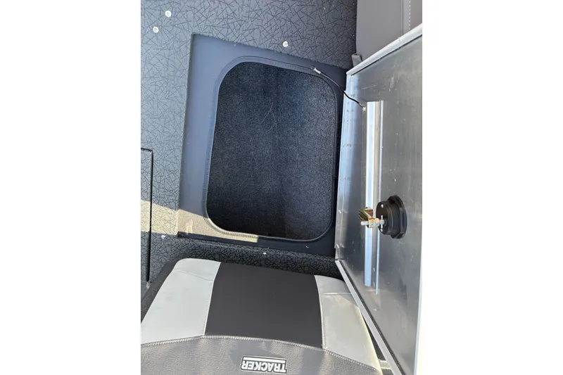 Slide: The Image of 2027 Tracker Pro Guide V-175 Combo boat interior storage compartment with open hatch and seat. - 32