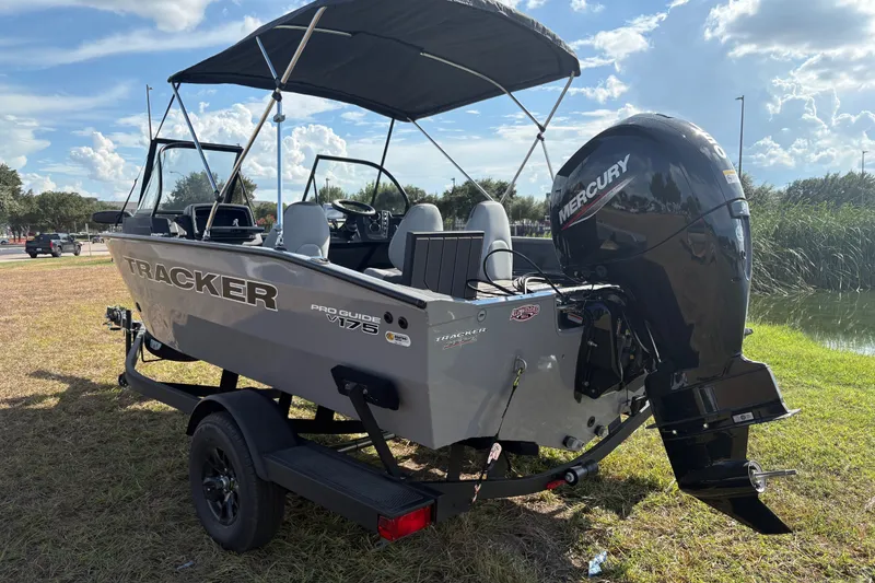 Slide: The Image of 2027 Tracker Pro Guide V-175 Combo boat with Mercury engine on grassy area. - 22