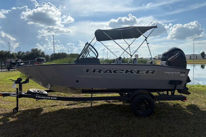 The Image of 2027 Tracker Pro Guide V-175 Combo boat on trailer, parked outdoors. - 2