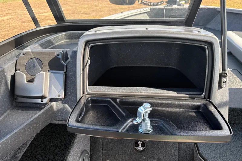Slide: The Image of 2027 Tracker Pro Guide V-175 Combo boat dashboard with open storage compartment. - 38