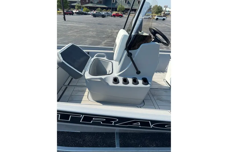 Slide: The Image of 2027 Tracker Bass Tracker Classic CC boat interior with steering console and seating. - 63