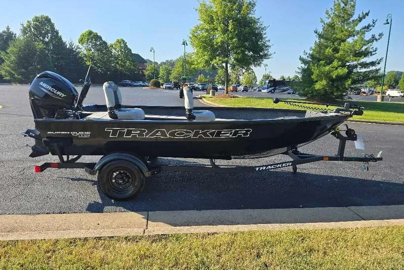 The Image of 2027 Tracker Super Guide V-16 T boat on trailer, parked outdoors. - 0