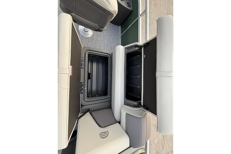 Slide: The Image of 2027 Sun Tracker Fishin' Barge 20 DLX interior storage compartment with open lid. - 21