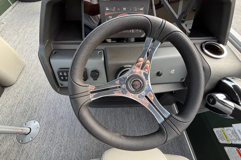 Slide: The Image of Steering wheel of 2027 Sun Tracker Fishin' Barge 20 DLX boat, featuring modern controls. - 15