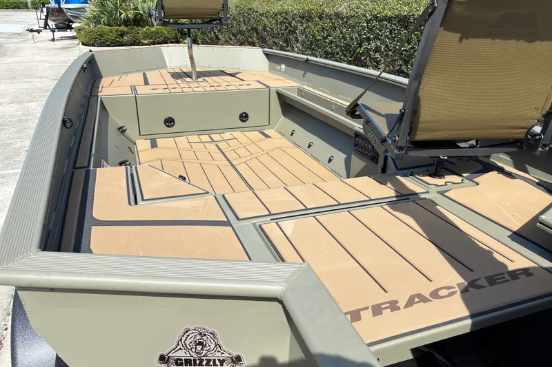 Slide: The Image of 2027 Tracker Grizzly 1553 Timber boat interior with seating and storage compartments. - 14