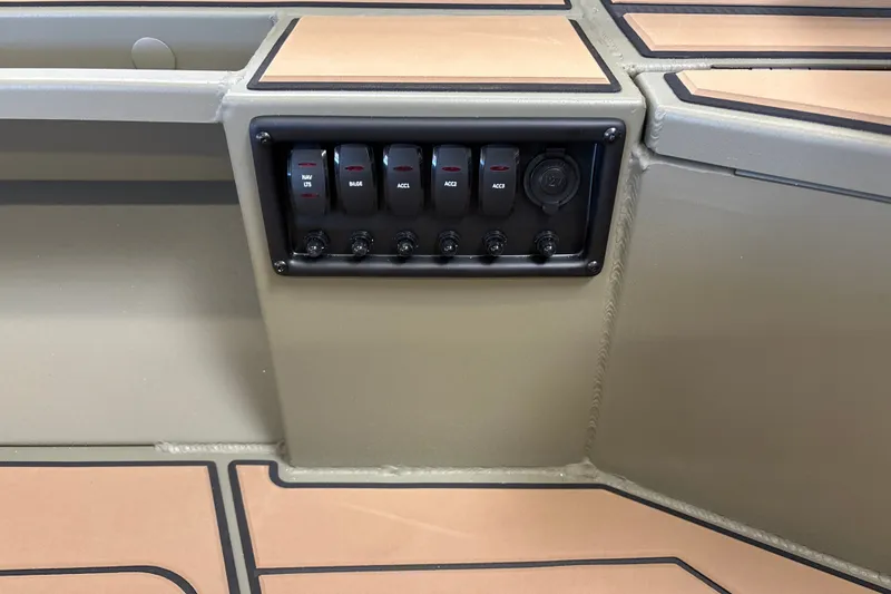 Slide: The Image of Control panel of 2027 Tracker Grizzly 1553 Timber boat with switches and outlets. - 17