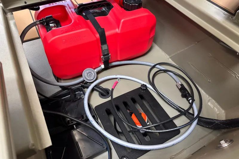 Slide: The Image of Interior view of a 2027 Tracker Grizzly 1553 Timber boat showing fuel tank and cables. - 22