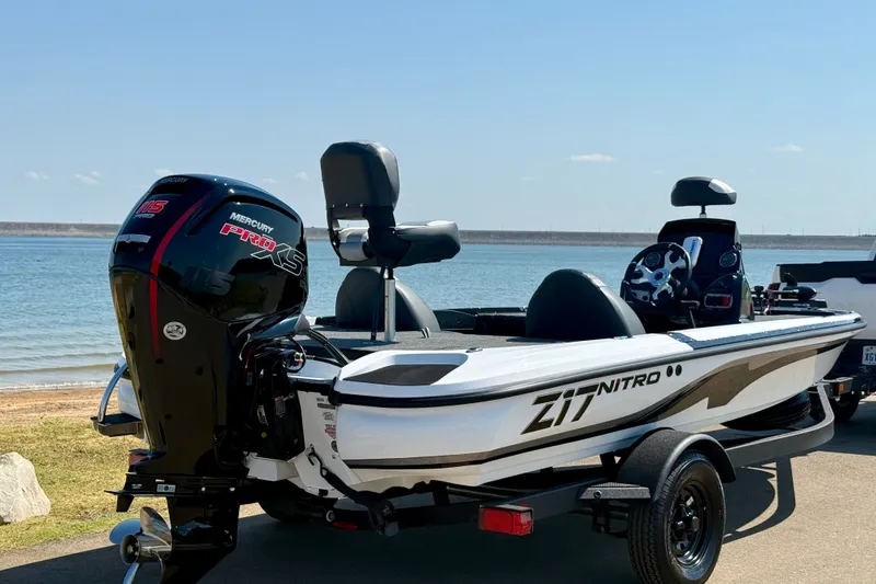 Slide: The Image of 2027 Nitro Z17 boat with Mercury Pro XS engine by a lake. - 13