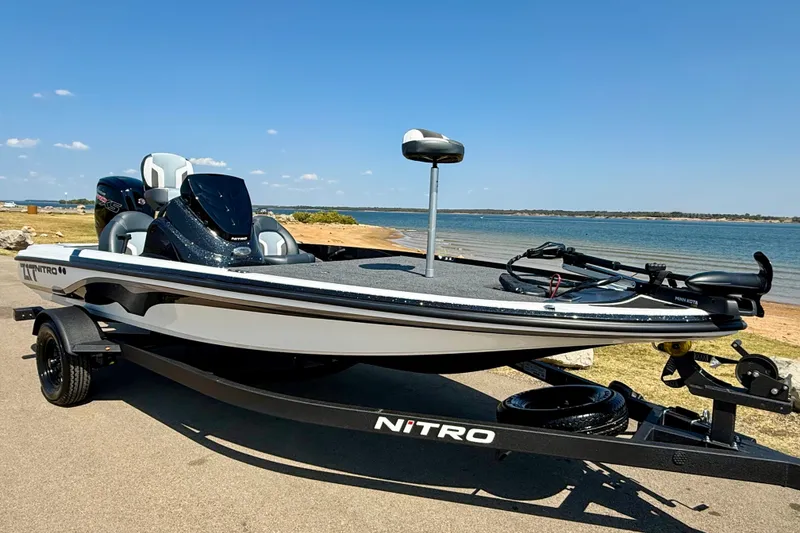 Slide: The Image of 2027 Nitro Z17 boat on trailer by a scenic lakeside. - 2