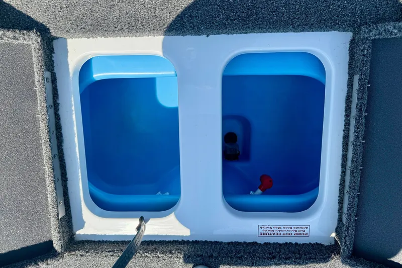 Slide: The Image of Open storage compartments in a 2027 Nitro Z17 boat, featuring blue interiors. - 11