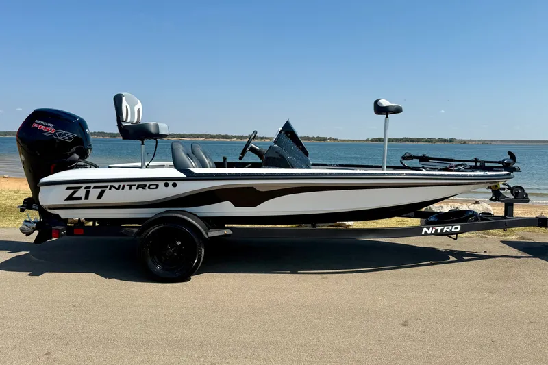 Slide: The Image of 2027 Nitro Z17 boat on trailer by a lake, featuring sleek design and Mercury Pro XS engine. - 3