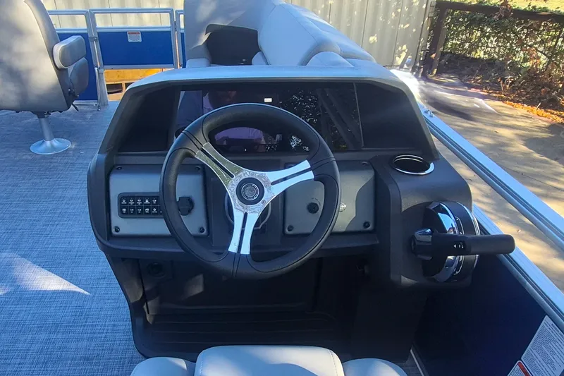 Slide: The Image of 2027 Sun Tracker SportFish 20 DLX boat dashboard with steering wheel and controls. - 13