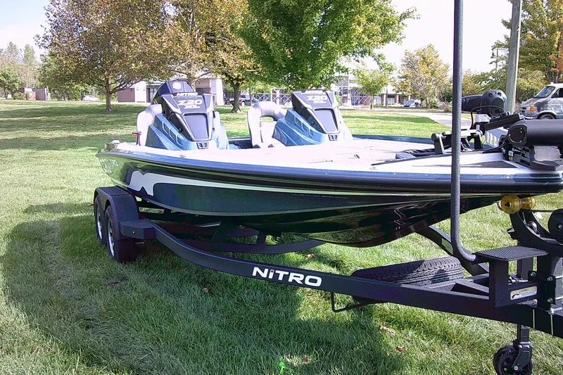 Slide: The Image of 2025 Nitro Z20 XL Pro boat on trailer, parked on grass with trees in background. - 2