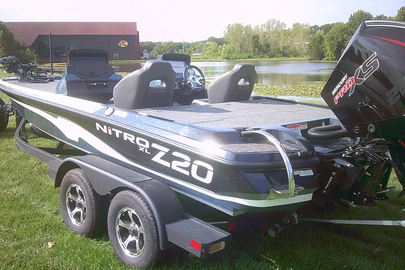 Slide: The Image of 2025 Nitro Z20 XL Pro boat on trailer by a scenic lake. - 1
