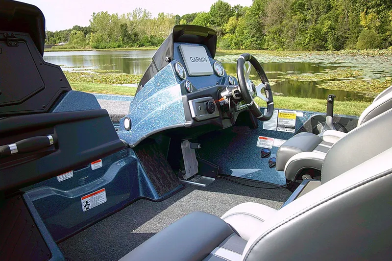 Slide: The Image of 2025 Nitro Z20 XL Pro boat interior with Garmin display, near a scenic lake. - 4