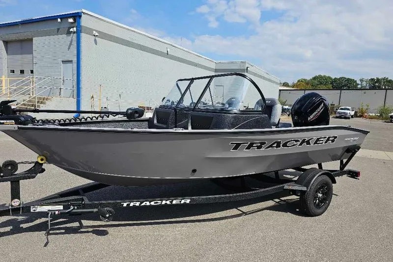 The Image of 2027 Tracker Pro Guide V-16 WT boat on trailer, parked outdoors. - 0