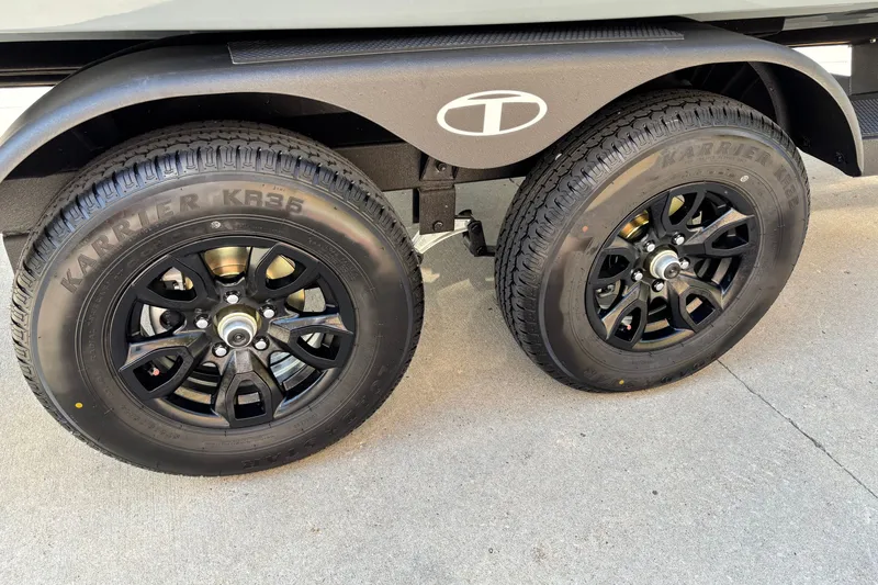 Slide: The Image of Dual black wheels on a 2027 Tahoe 2150 trailer, featuring Karrier KR35 tires. - 15