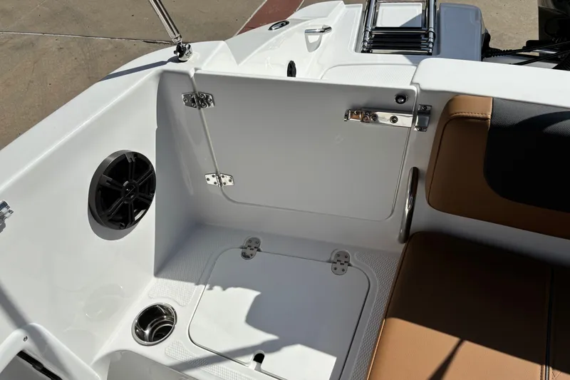 Slide: The Image of 2027 Tahoe 2150 boat interior with speaker, cup holder, and seating area. - 14