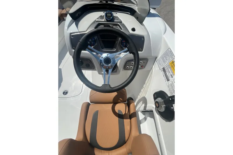 Slide: The Image of Steering wheel and dashboard of 2027 Tahoe 1950 boat with tan seating. - 4