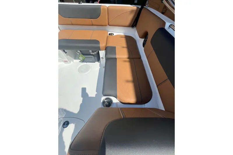 Slide: The Image of Luxurious seating in 2027 Tahoe 1950 boat, featuring brown and black upholstery. - 10