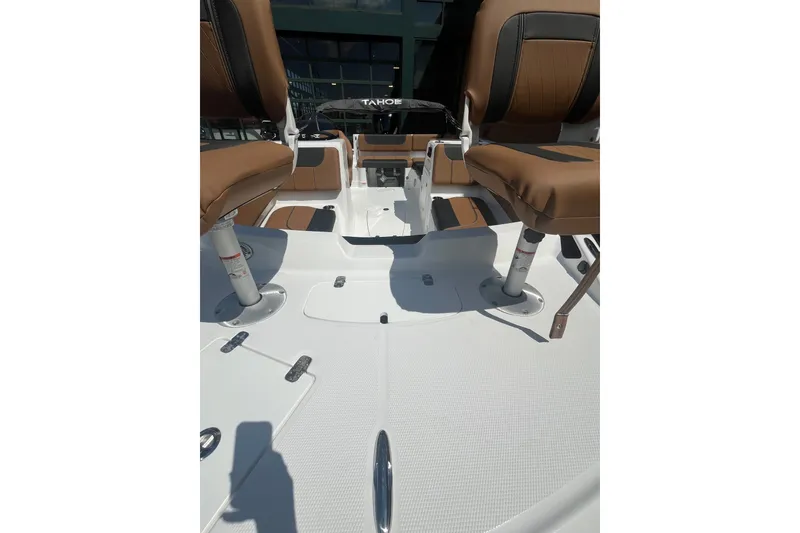 Slide: The Image of Interior view of 2027 Tahoe 1950 boat with brown seating and white deck. - 3