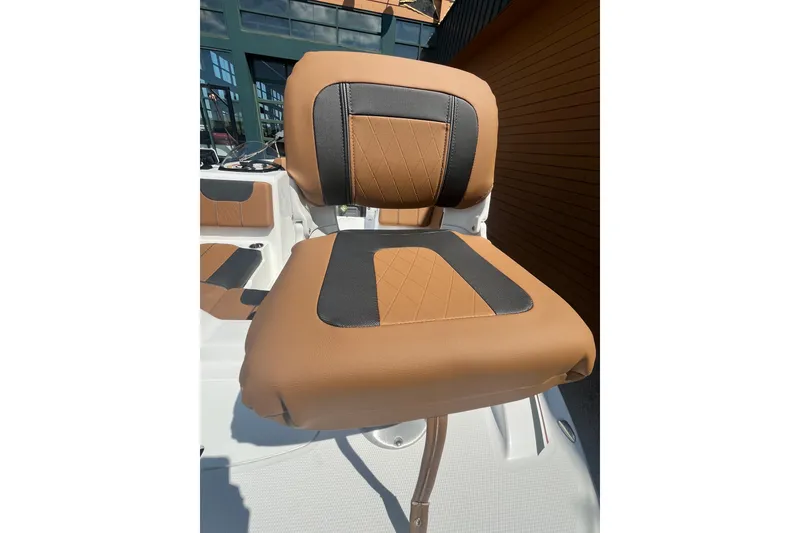 Slide: The Image of Brown and black cushioned seat on 2027 Tahoe 1950 boat, outdoor setting. - 5