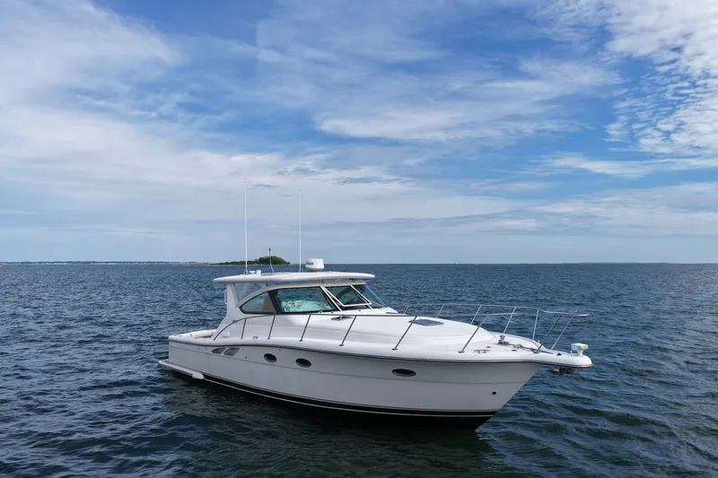 The Image of 2001 Tiara Yachts 3800 Open cruising on calm ocean waters under a blue sky. - 1