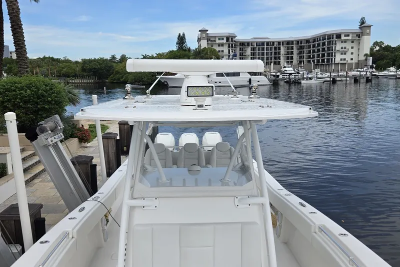 Slide: The Image of 2018 Invincible 39 Open Fisherman boat docked near waterfront buildings. - 20
