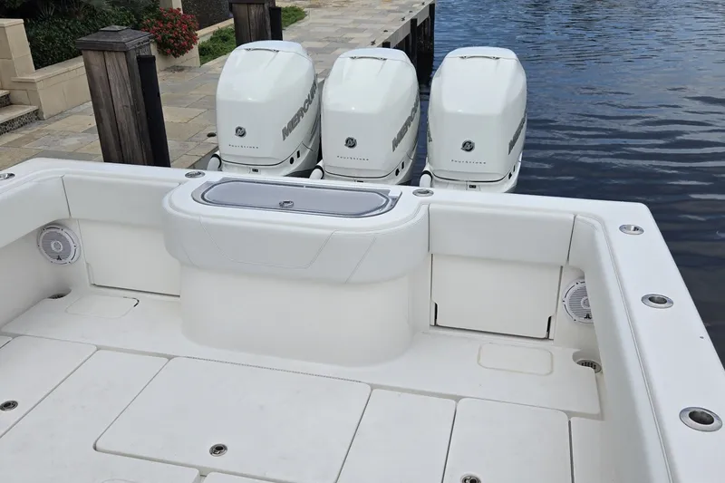 Slide: The Image of 2018 Invincible 39 Open Fisherman boat with triple Mercury engines docked by the water. - 19