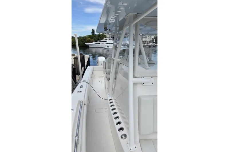Slide: The Image of 2018 Invincible 39 Open Fisherman boat docked, showcasing sleek white design and spacious deck. - 21