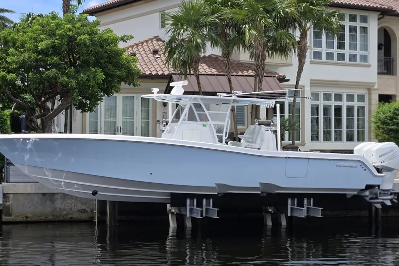 The Image of 2018 Invincible 39 Open Fisherman boat docked near a waterfront home. - 1