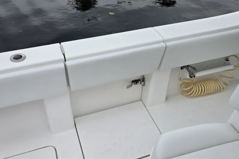 Slide: The Image of 2018 Invincible 39 Open Fisherman boat interior with white seating and coiled hose. - 30