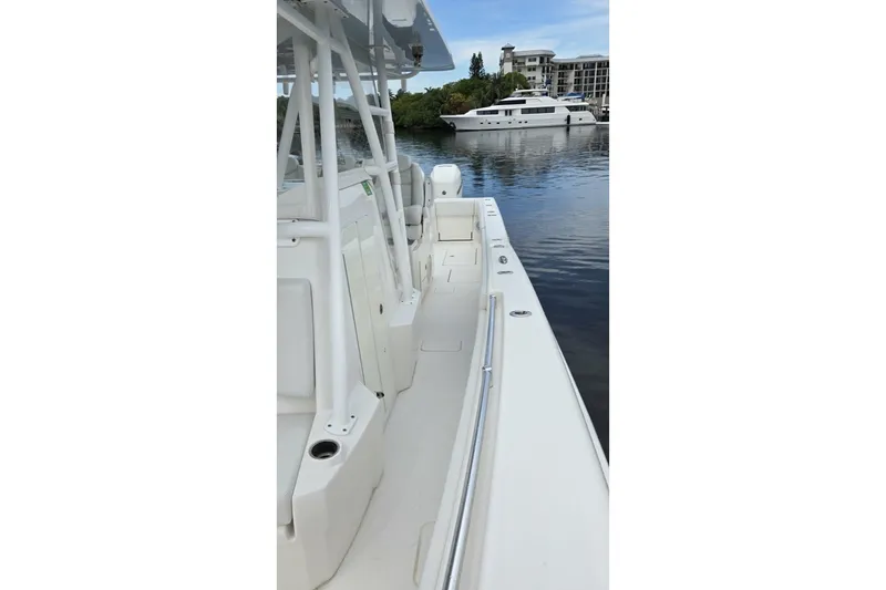 Slide: The Image of 2018 Invincible 39 Open Fisherman boat docked on calm water, showcasing sleek design. - 18