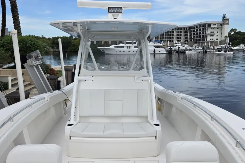 Slide: The Image of 2018 Invincible 39 Open Fisherman boat docked at marina with scenic waterfront view. - 14