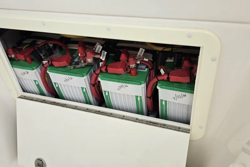 Slide: The Image of Battery compartment of 2018 Invincible 39 Open Fisherman with multiple batteries and red cables. - 33