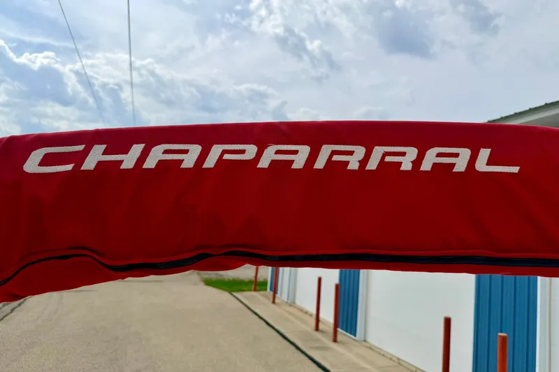 Slide: The Image of Red Chaparral Sunesta 216 boat cover with logo, 2006 model, under a cloudy sky. - 81