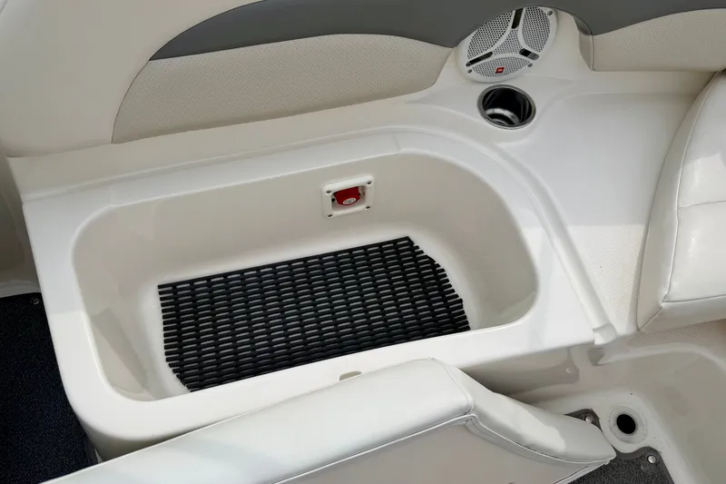 Slide: The Image of 2006 Chaparral Sunesta 216 boat interior storage compartment with speaker and cup holder. - 30