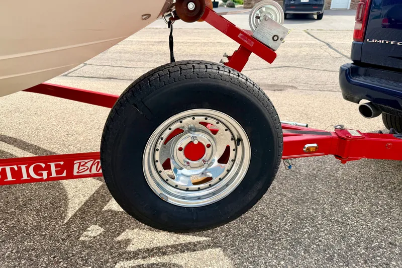 Slide: The Image of Trailer wheel of 2006 Chaparral Sunesta 216 boat on red Prestige trailer. - 91