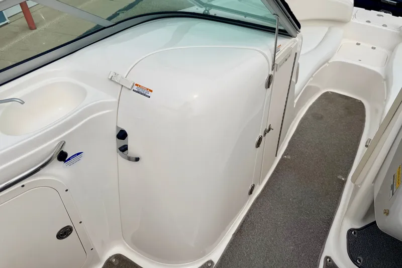 Slide: The Image of 2006 Chaparral Sunesta 216 boat interior with seating and storage compartments. - 78