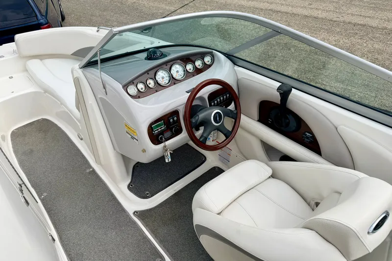 Slide: The Image of 2006 Chaparral Sunesta 216 boat interior with steering wheel and dashboard controls. - 77
