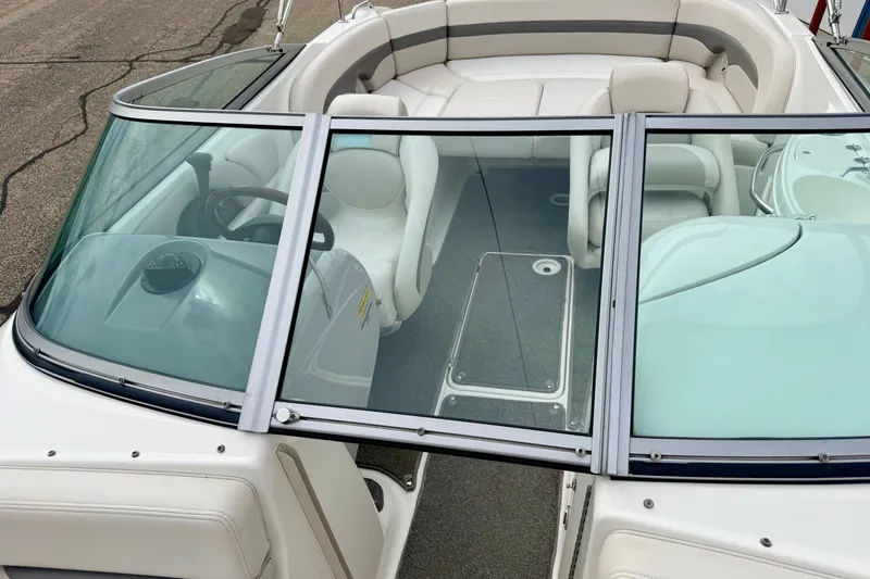 Slide: The Image of 2006 Chaparral Sunesta 216 boat interior with white seating and windshield. - 60