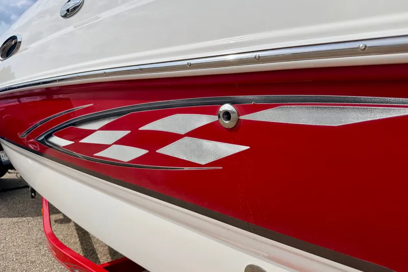 Slide: The Image of 2006 Chaparral Sunesta 216 boat with red and white checkered design detail. - 11