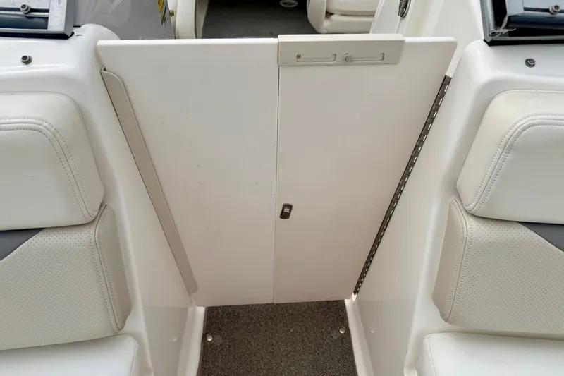 Slide: The Image of 2006 Chaparral Sunesta 216 interior with white seating and closed cabin door. - 62